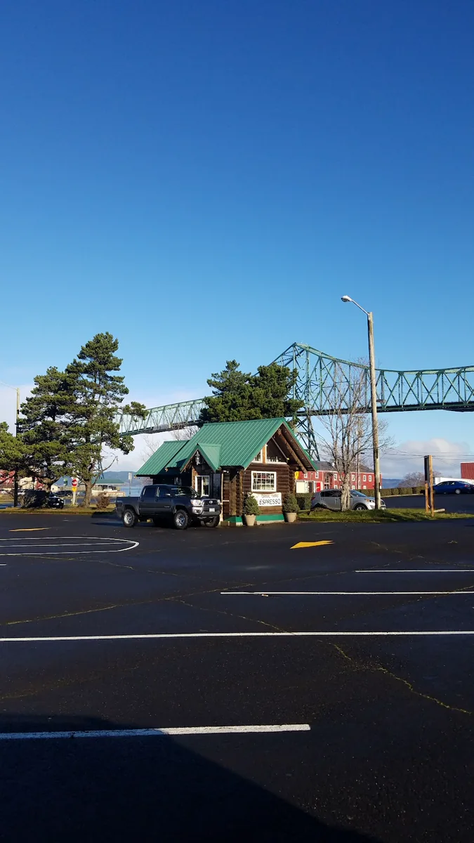 The drive-through espresso kiosk seen from the parking area near the bridge