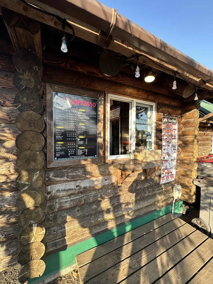 A sunlit close view of the espresso kiosk service window and menu boards